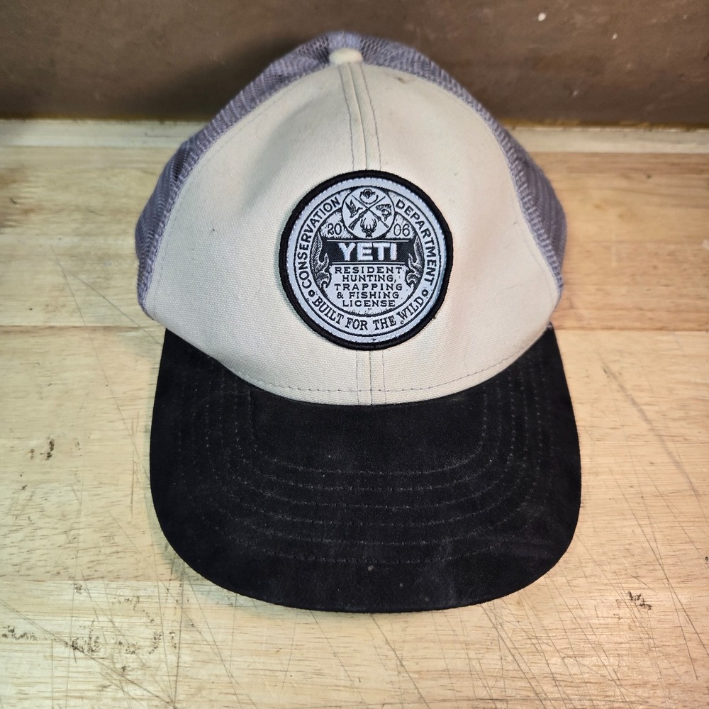 YETI License Badge Hat Taupe/Black. Conservation Department